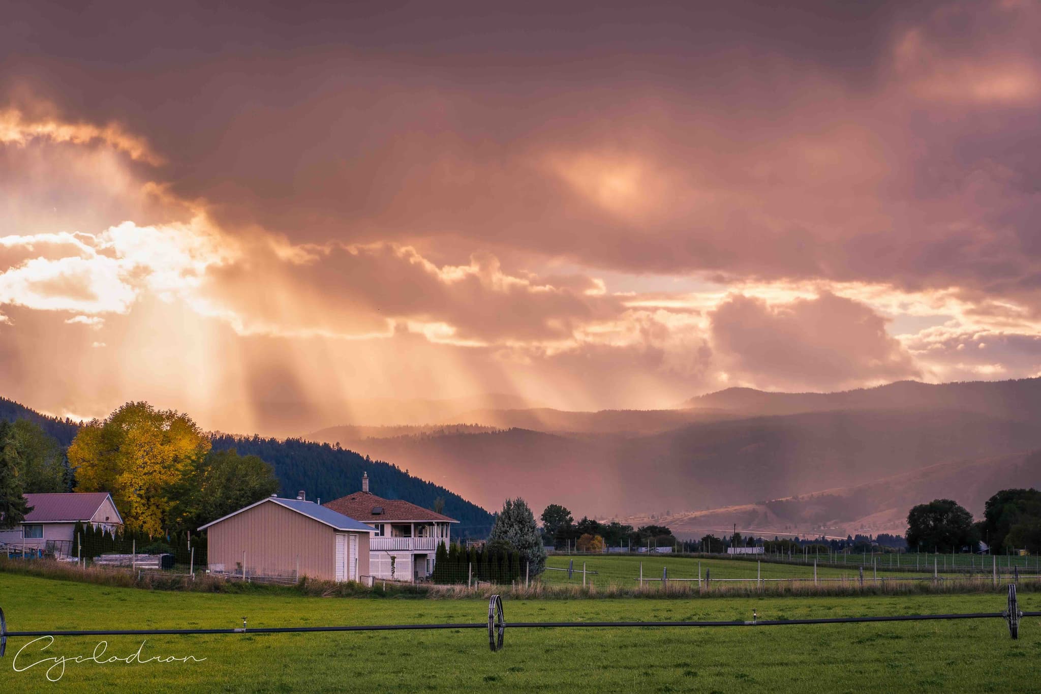 Dramatic sunset with god rays over mountain landscape